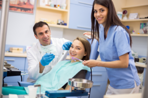 a dental assistant working and smiling