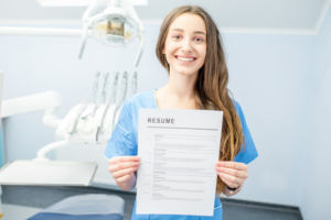 a dental assistant holding her resume