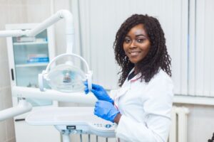 Happy dental assistant in treatment room